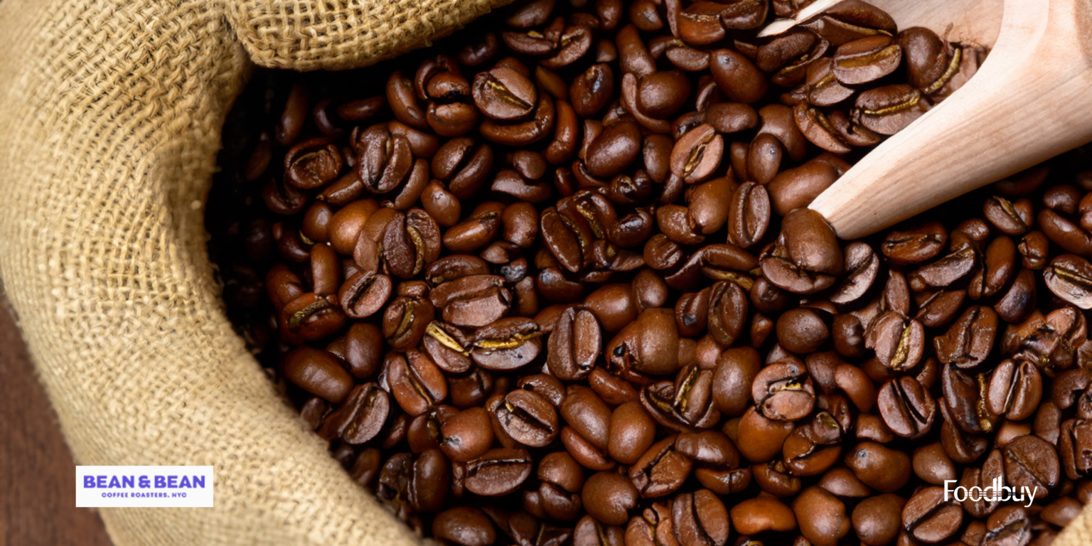 coffee beans being scooped out of a bag. Feature on Foodbuy Supplier: Bean & Bean Coffee Roasters