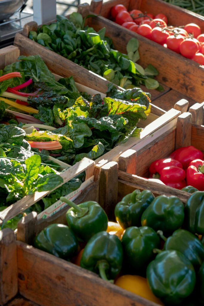 Crates of fresh vegetables at a farm stand, highlighting locally sourced produce